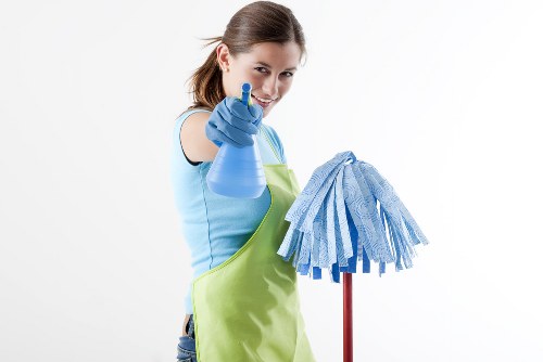 Carpet cleaner preparing equipment safely in Old Oak Common