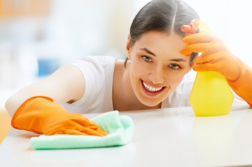 Cleaner wearing PPE during carpet cleaning work